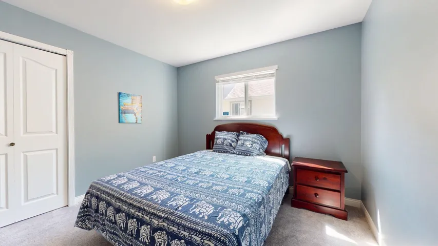 Bedroom featuring carpet, baseboards, and a closet