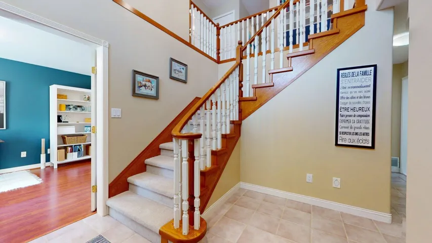 Stairs featuring baseboards and tile patterned flooring