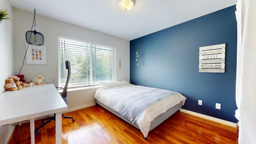 Bedroom with baseboards and wood finished floors