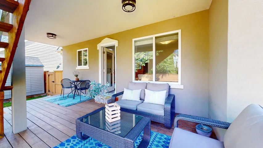 Wooden terrace with an outdoor living space and fence