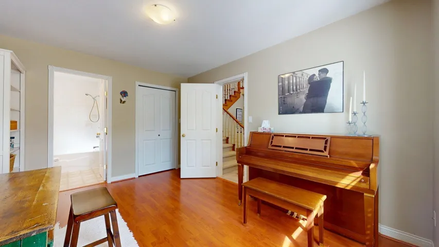 Living area with wood finished floors, stairs, and baseboards