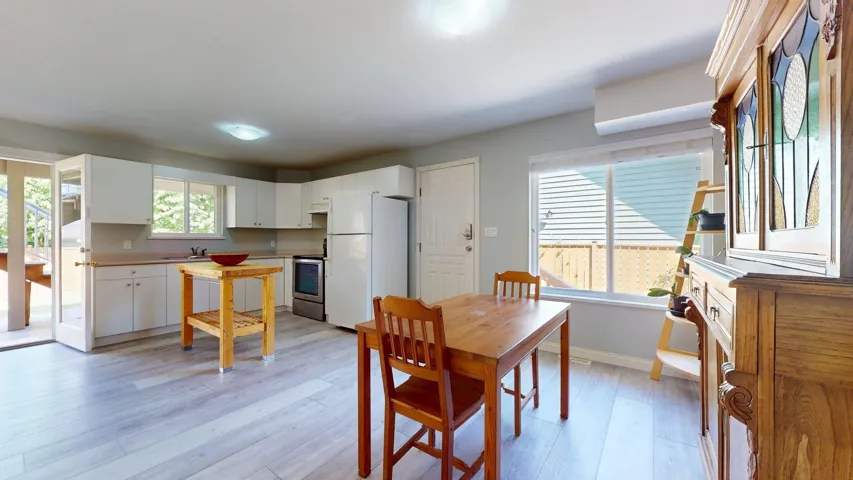 Dining space with light wood-style flooring and baseboards