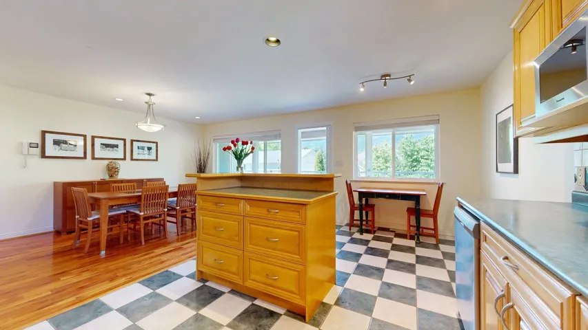 Kitchen featuring appliances with stainless steel finishes, light flooring, recessed lighting, baseboards, and pendant lighting