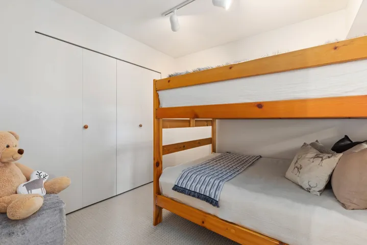 Bedroom featuring a closet and track lighting
