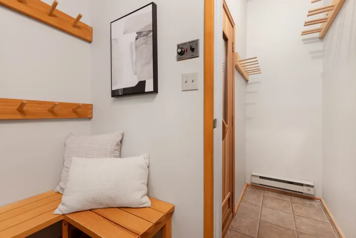Interior space featuring a baseboard heating unit and tile patterned flooring