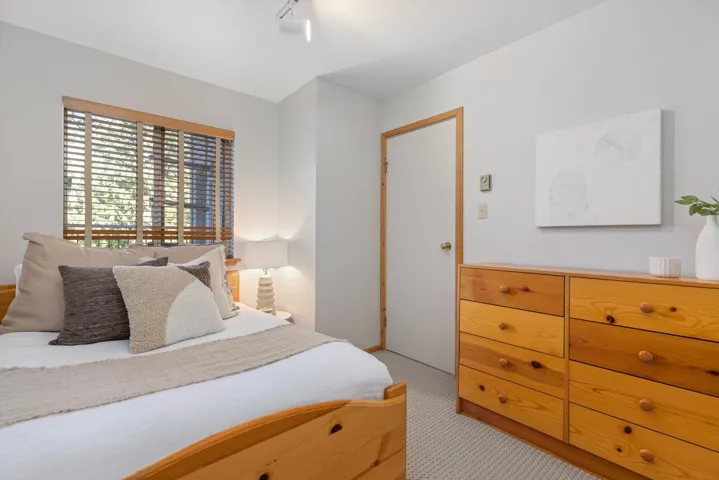 Bedroom featuring light colored carpet