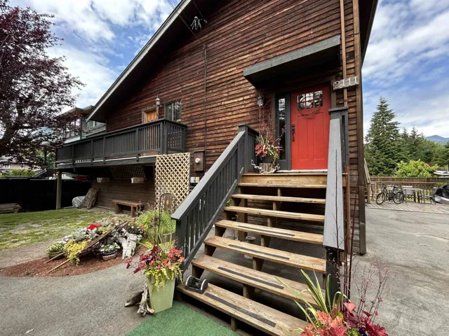 View of exterior entry with a wooden deck