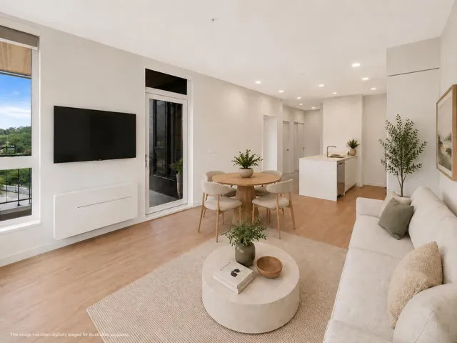Open-concept living space featuring wood-finish flooring, recessed lighting, and a white color palette