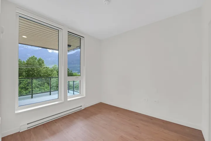Room with light wood-finish flooring and white walls