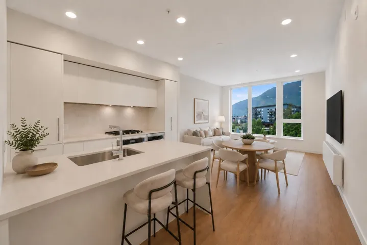 Open-concept living area with wood-finish flooring