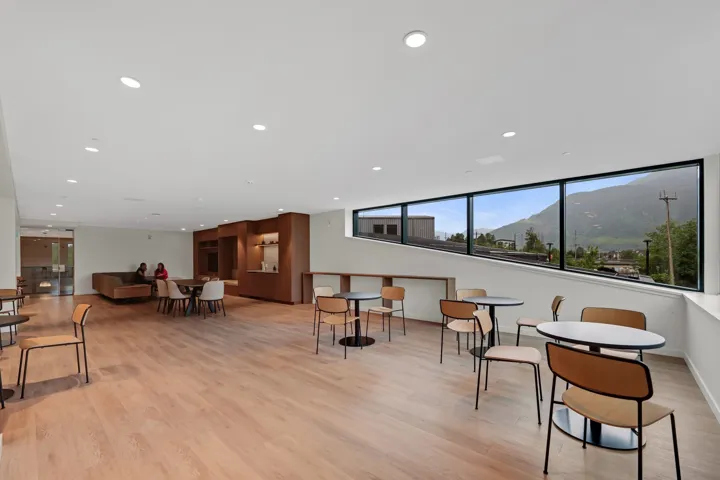 Spacious common area featuring wood-finish flooring and extensive recessed lighting
