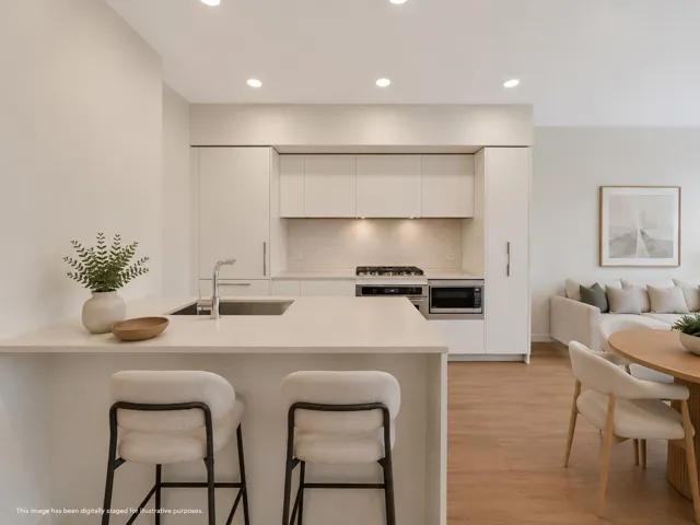 Contemporary kitchen featuring an integrated stainless steel sink, gas range, built-in microwave, and pendant lighting