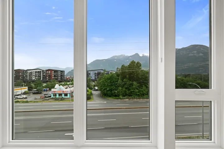 Expansive windows featuring white frames, multi-pane design, and a clear glass composition
