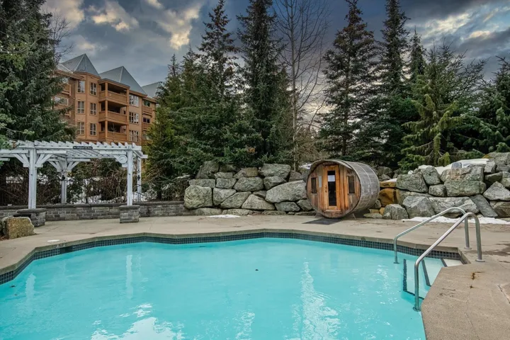 Swimming pool with a patio area and a pergola