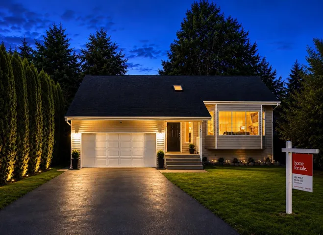 Siding exterior with an attached garage and an asphalt driveway