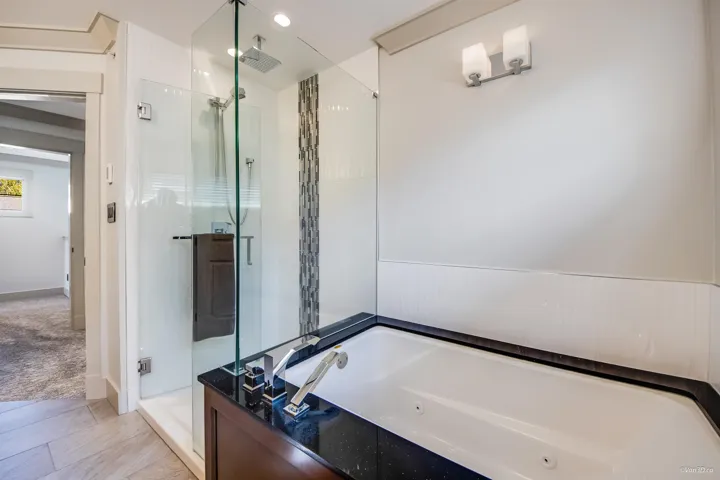 Bathroom featuring a whirlpool tub, a stall shower, and visible vents
