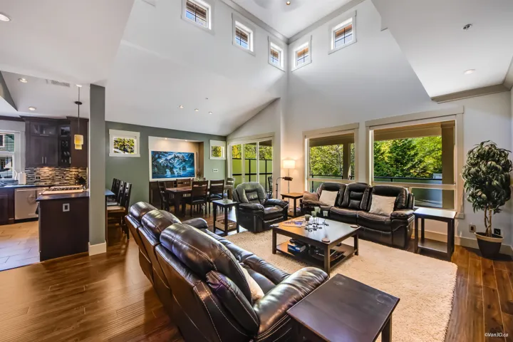 Living area featuring baseboards, wood finished floors, and plenty of natural light