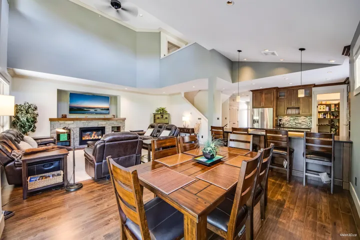 Dining room featuring dark wood-style floors, visible vents, a fireplace, and recessed lighting