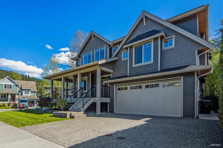 Craftsman house featuring a garage, covered porch, and aphalt driveway