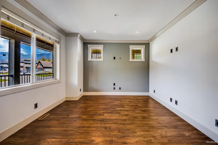 Unfurnished room featuring visible vents, ornamental molding, dark wood-style floors, and baseboards