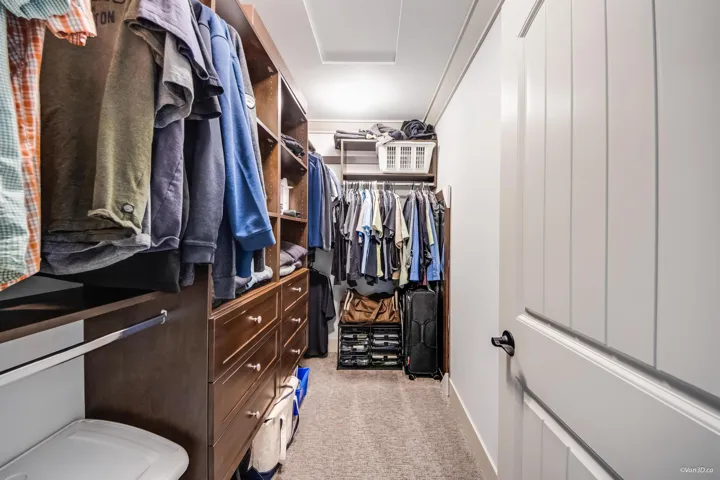Spacious closet with attic access and light colored carpet
