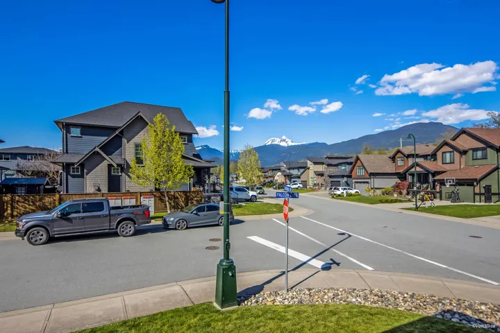 View of road with street lights, a mountain view, and a residential view