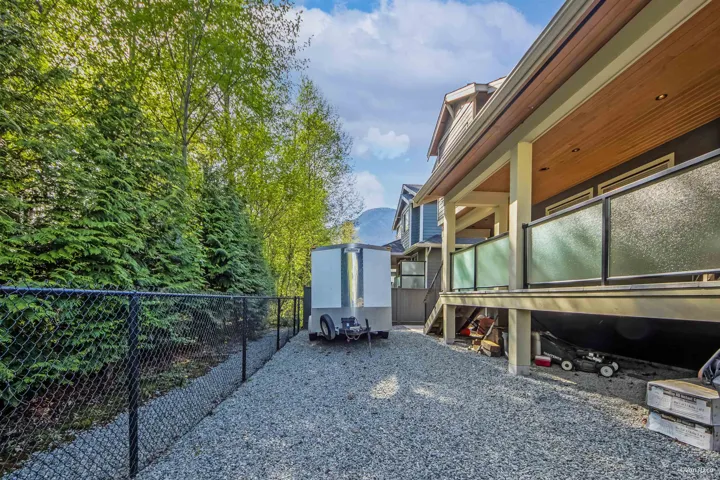 View of side of home featuring fence