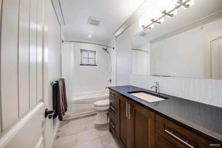 Bathroom featuring visible vents, shower / tub combo with curtain, toilet, recessed lighting, and vanity