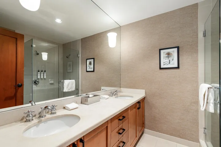Double vanity featuring undermount sinks, chrome fixtures, and a light-toned countertop