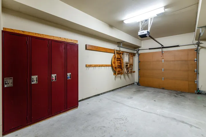 Garage interior with concrete flooring and a wood-panel garage door