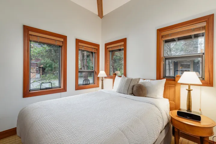Room featuring multiple windows with wood trim and integrated blinds