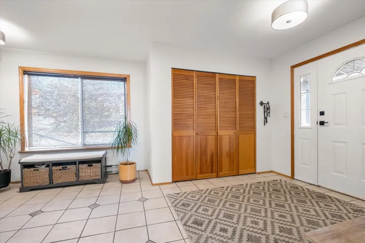 Foyer featuring light tile patterned floors and baseboards