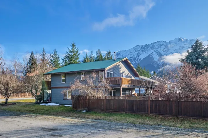 View of property exterior featuring a deck with mountain view