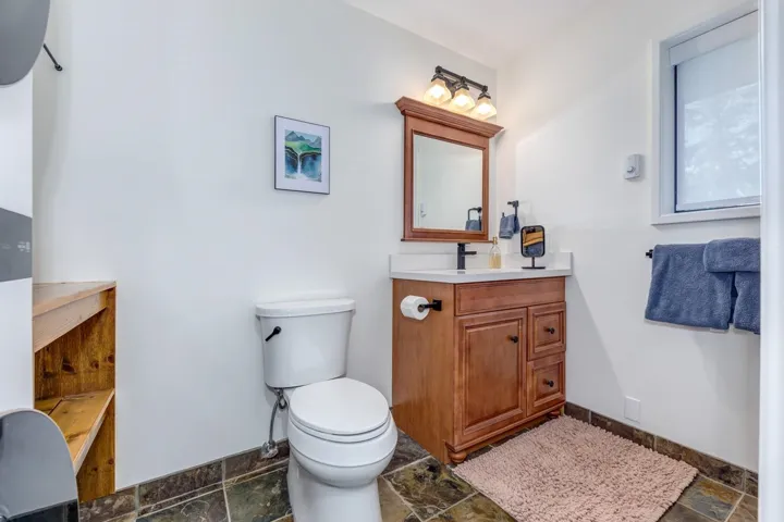 Bathroom featuring stone tile flooring and vanity