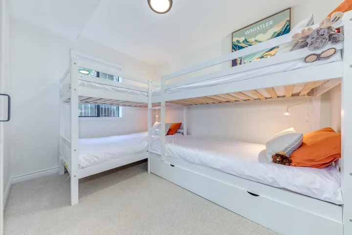 Bedroom with light colored carpet and baseboards