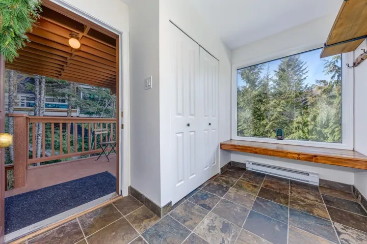 Mudroom featuring stone tile flooring and a baseboard heating unit