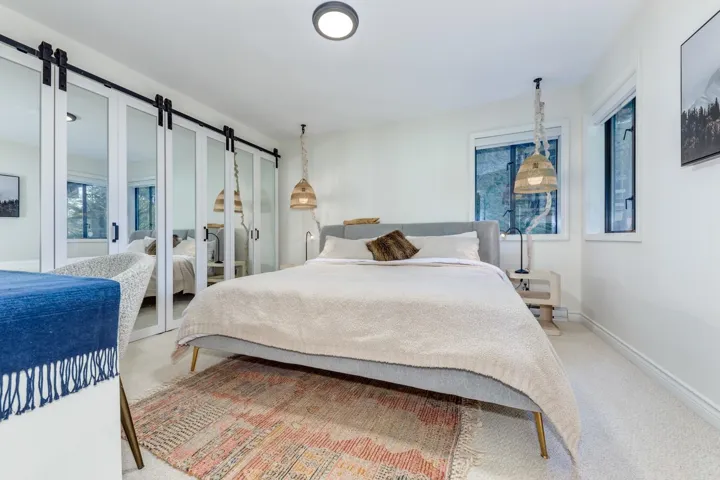 Bedroom with a barn door and light carpet