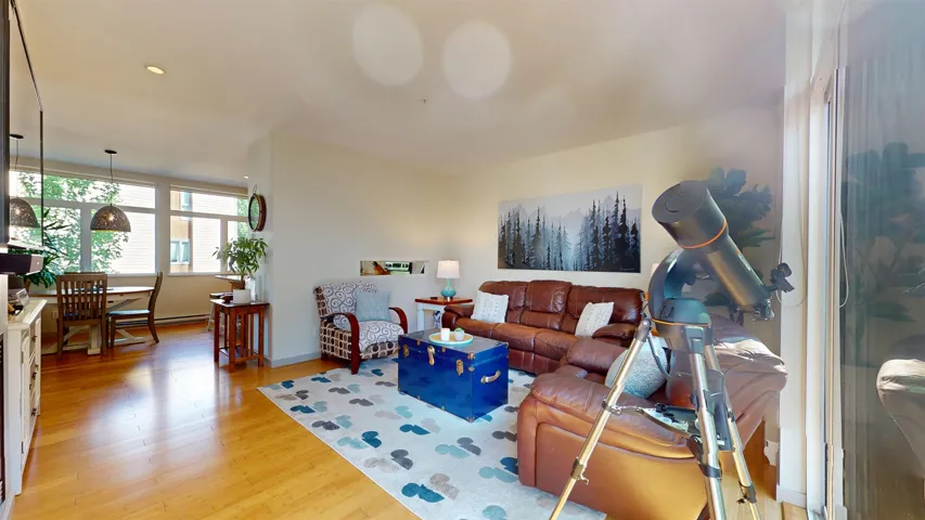 Living area featuring light wood finished floors and recessed lighting