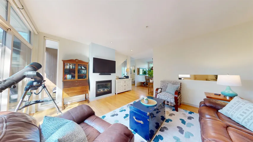 Living area with light wood finished floors and a  fireplace