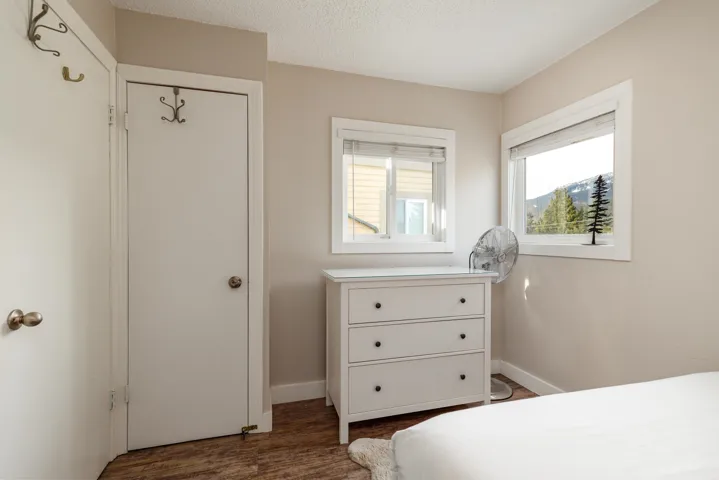 Bedroom with dark wood-style flooring and a textured ceiling