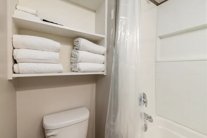 Bathroom featuring shower / tub combo and toilet