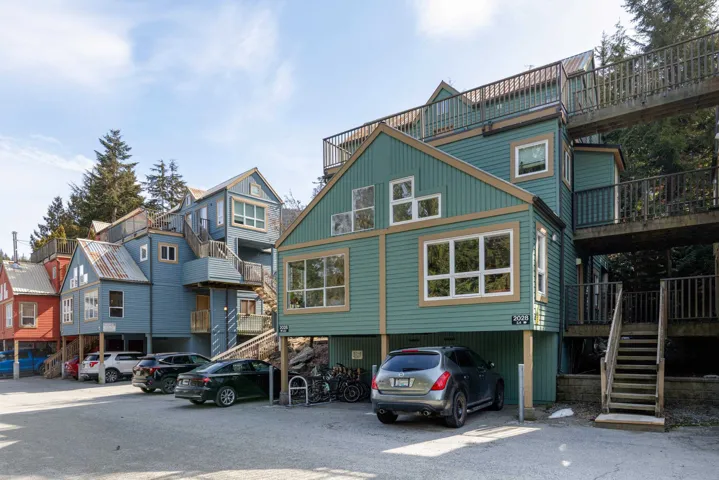 Back of property featuring a residential view and a carport