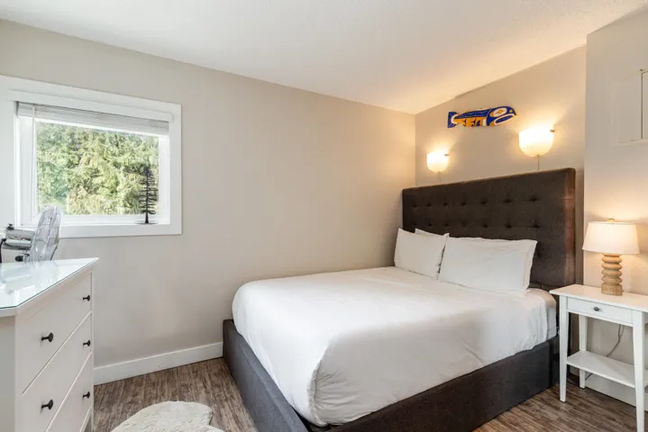 Bedroom featuring dark wood-style floors and baseboards