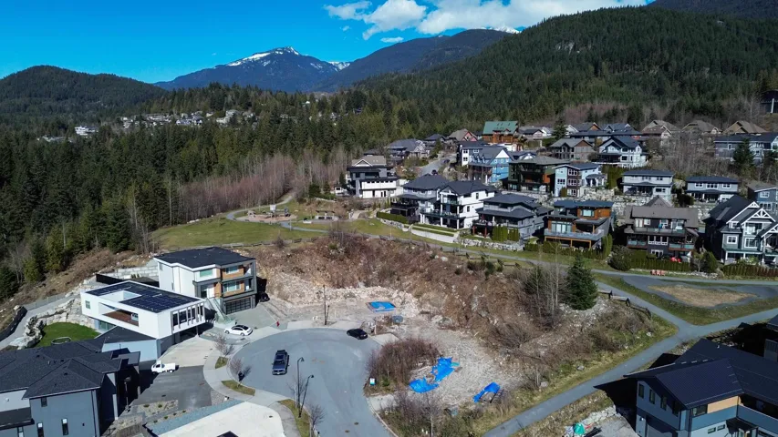 Drone / aerial view featuring a wooded view, a mountain view, and a residential view