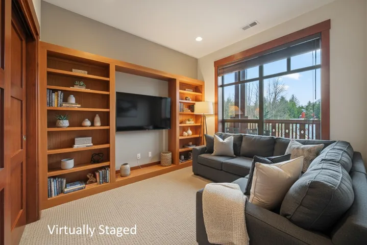 Living area with recessed lighting and carpet floors