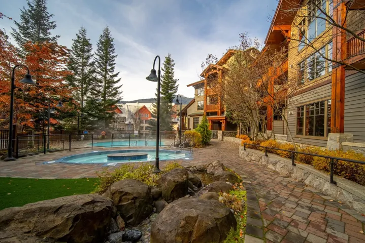 View of pool featuring a fenced backyard, a patio area, and a pool with connected hot tub