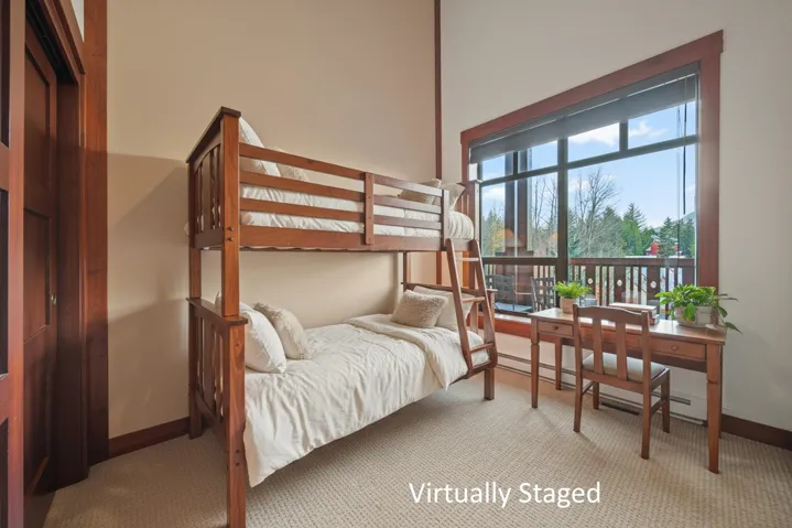 Bedroom featuring carpet flooring and a baseboard heating unit