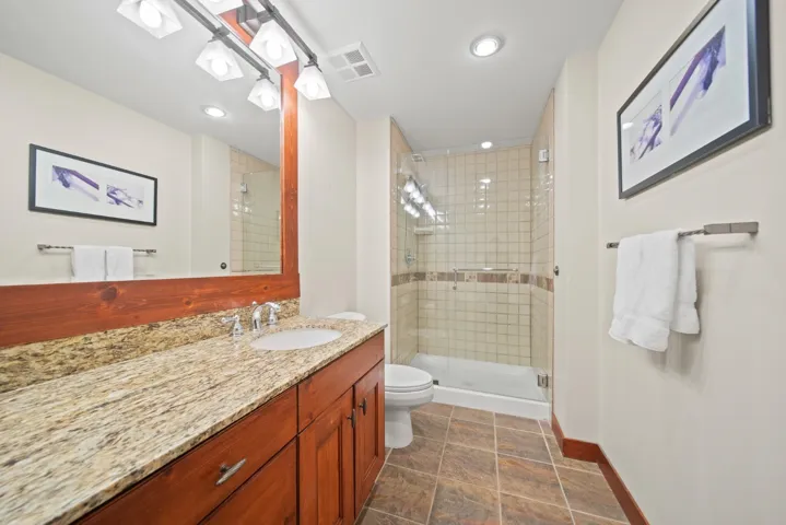 Bathroom with vanity, a stall shower, and recessed lighting