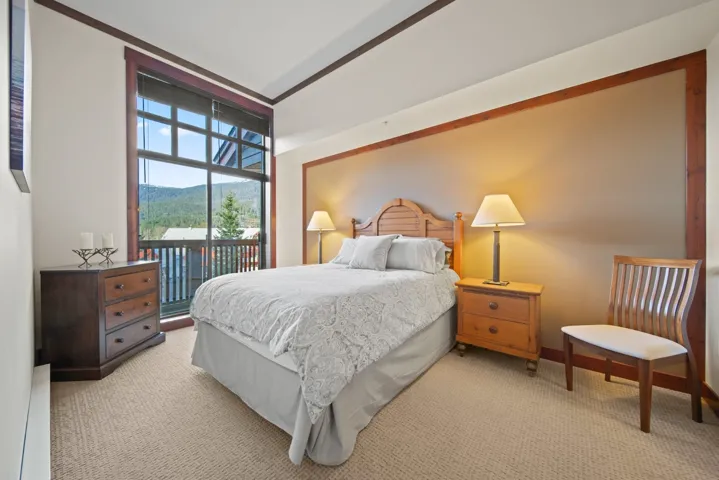 Carpeted bedroom featuring access to outside and a mountain view