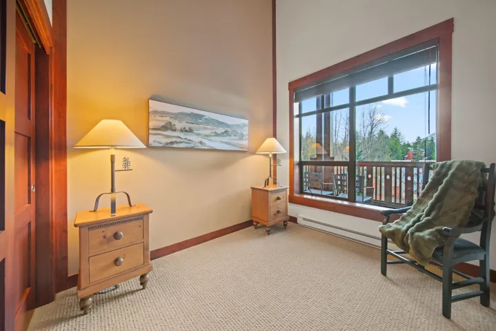 Sitting room with baseboards and carpet flooring